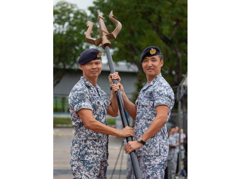 COL Foong Kok Pun (left) handing over the symbol of command for NDU to the incoming Commander NDU, COL Chew Kuok Hsin (right).