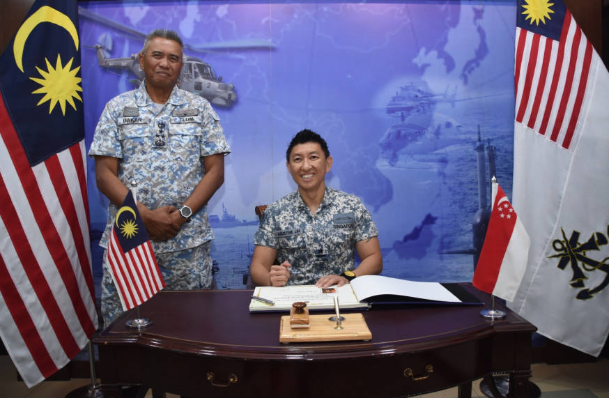RADM Lim signed a guestbook to commemorate his visit to Lumut Naval Base.