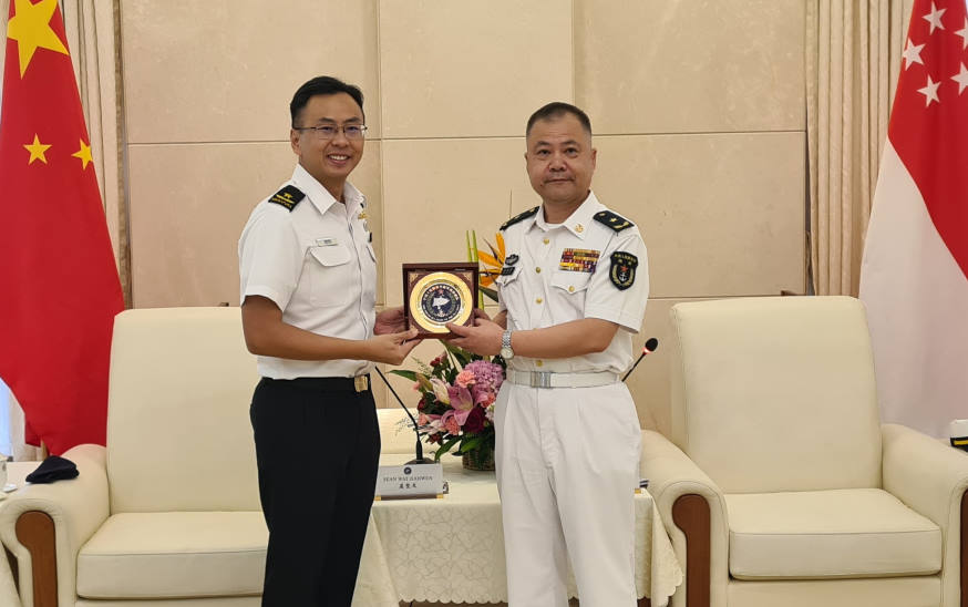RADM Xu Haihua presenting a plaque to RADM Wat at the courtesy call