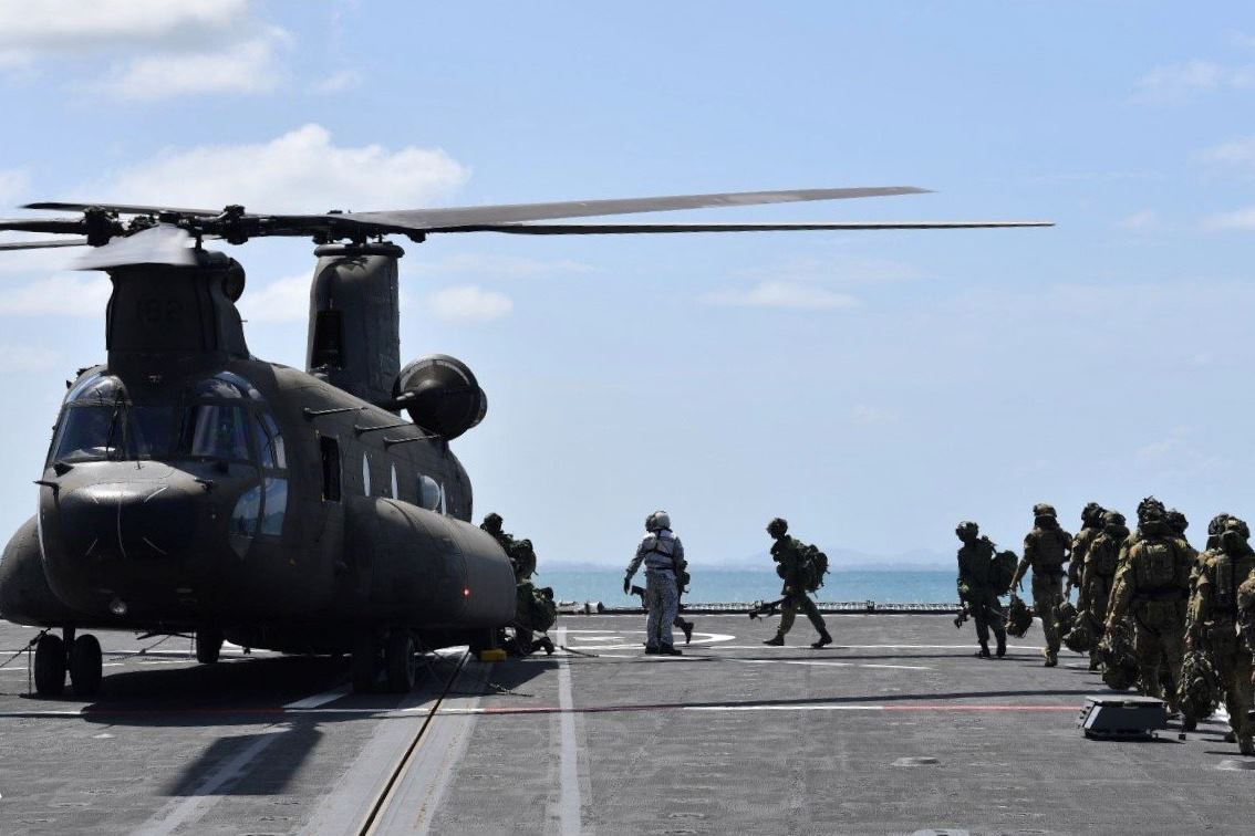 SAF and ADF troops boarding the RSAF's Chinook helicopter on board the RSN's RSS Resolution for a troop insertion mission during Exercise Trident in Shoalwater Bay Training Area, Australia.