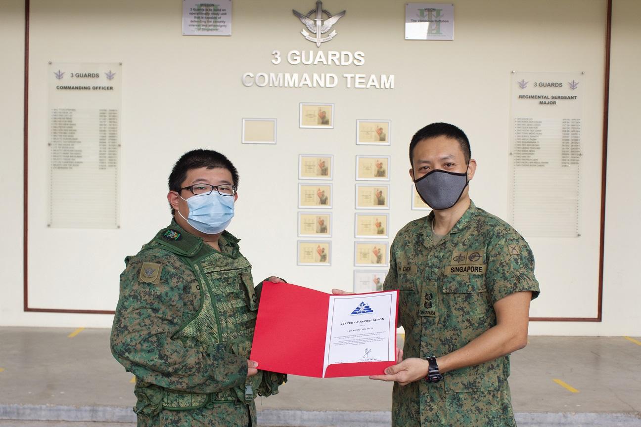 LCP Kwok receiving a letter of appreciation for his hard work, presented by Head, Human Resource Institute (HRI), LTC Chen Ting Wei.