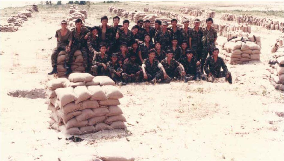 EOD teams posing with the rows of protective works prepared for the disposal.