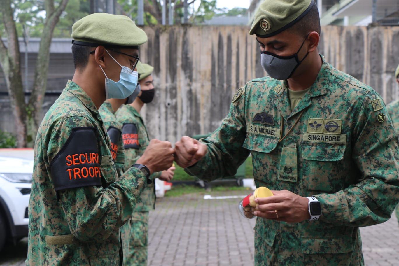 MAJ Shaun Michael (right) thanking his security troopers during the Military Police and Security Troopers Recognition Day.