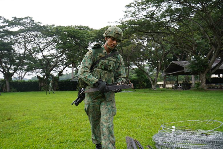 CPL Somil Mahesh Batavia, Armoured Pioneer, setting up concertina wires to fortify the area.
