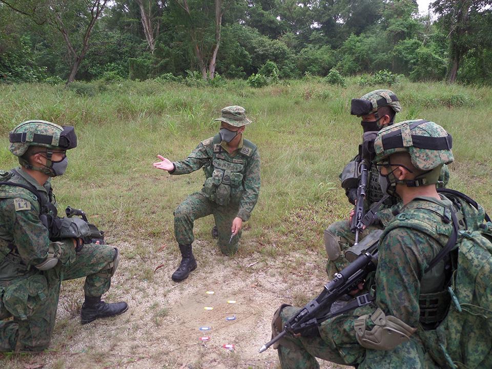 SSG Toh Zhi Hong (middle) engaging his trainees, making sure that they understand the training procedures.