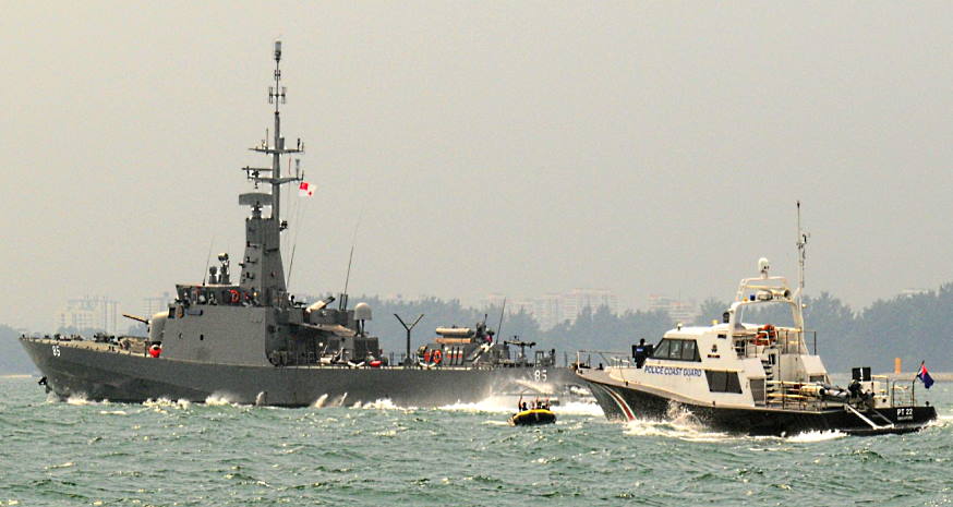 Honing our interoperability with the Ministry of Home Affairs: RSS Justice working together with a PCG patrol craft to intercept a "hostile boat" during Exercise Highcrest.