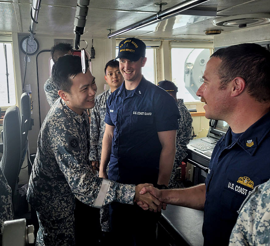 Commanding Officer MSRV Bastion MAJ Cheh Guo Jun (center) welcoming sea riders from USCGC Midgett on board.