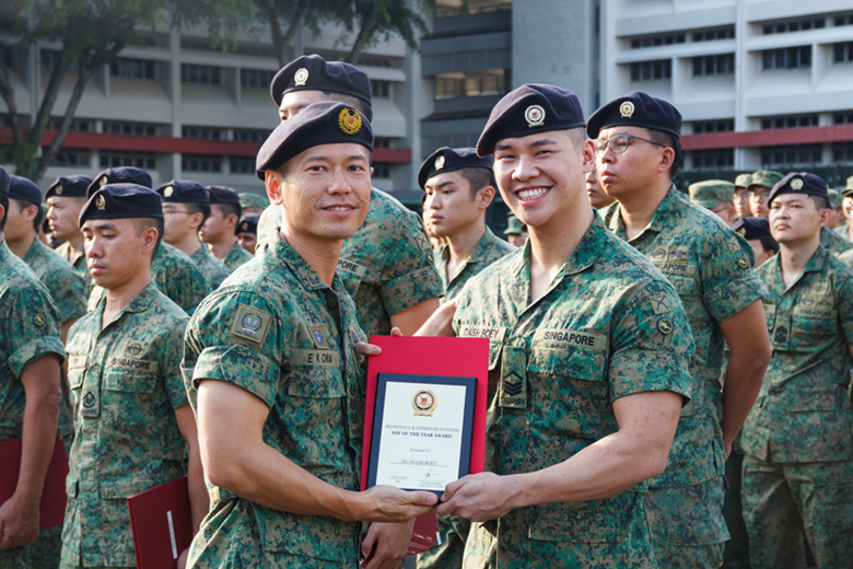 2SG (NS) Joash Boey being awarded the Signal Formation's NSF of the Year award by Commander Signal Institute, COL Chua Eng Khim.