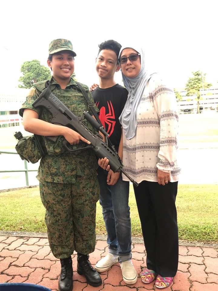 SV1 Qistina (left) with her youngest brother and mother during her Formation Patch Presentation Ceremony in 2018.