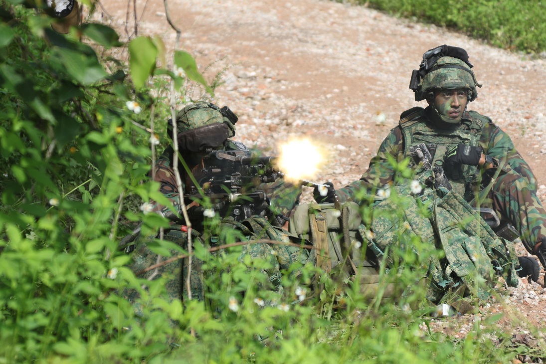 One of the OPFOR soldiers firing the General-Purpose Machine Gun.