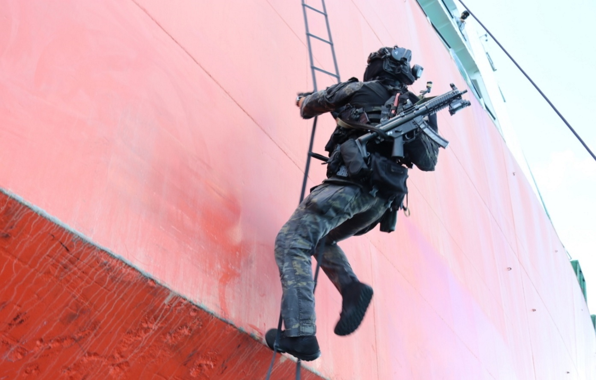 An RSN naval diver boarding a vessel of interest, simulated by MV Avatar as part of the maritime counter-terrorism training with their USN counterparts.