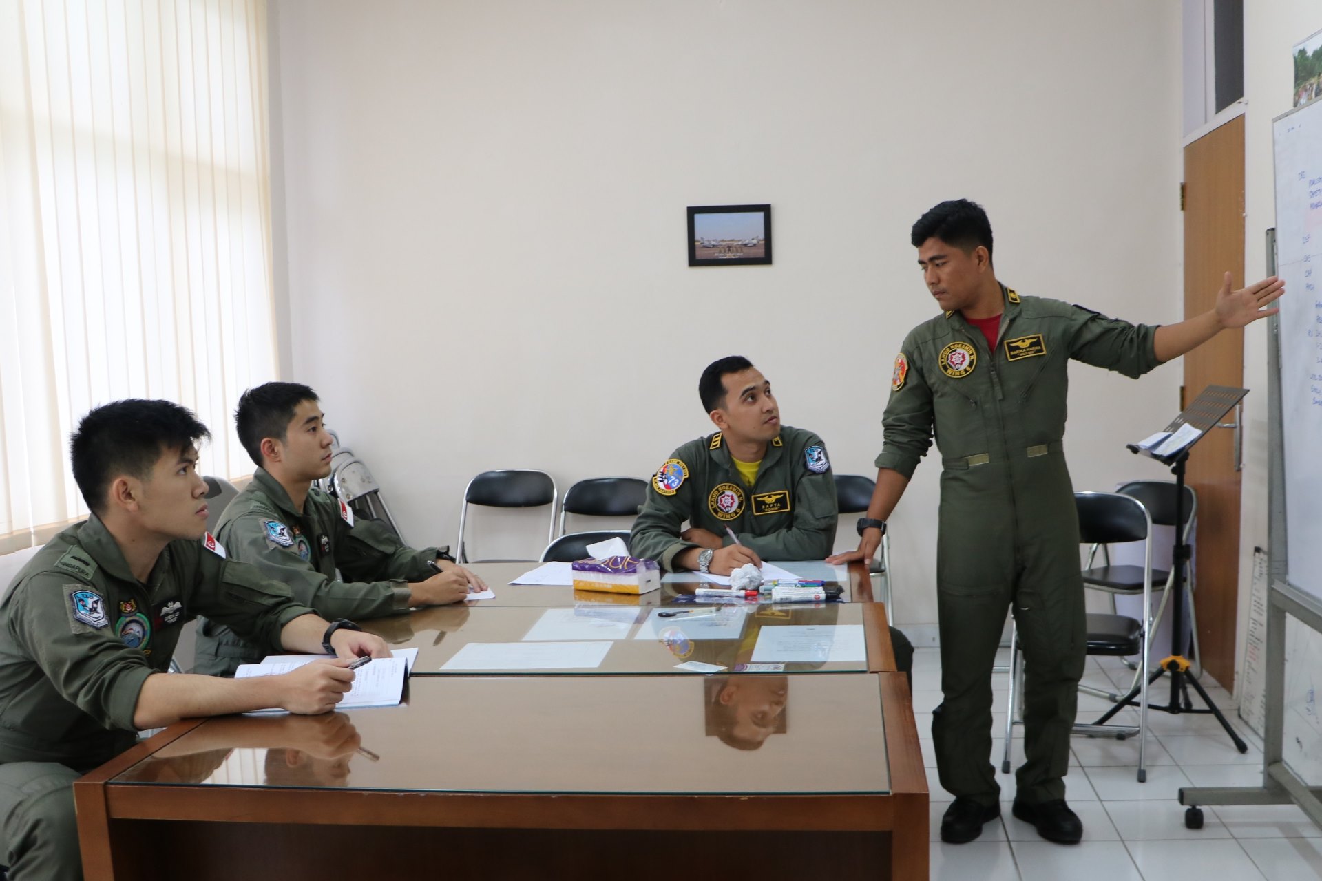 RSAF and TNI AU personnel conducting mission planning together before the flight.
