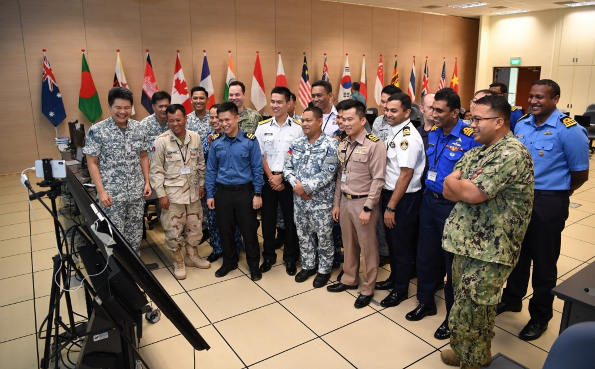 Exercise SEACAT participants at the Combined Maritime Coordination Centre (CMCC) set up at the RSN's Changi Command and Control Centre.