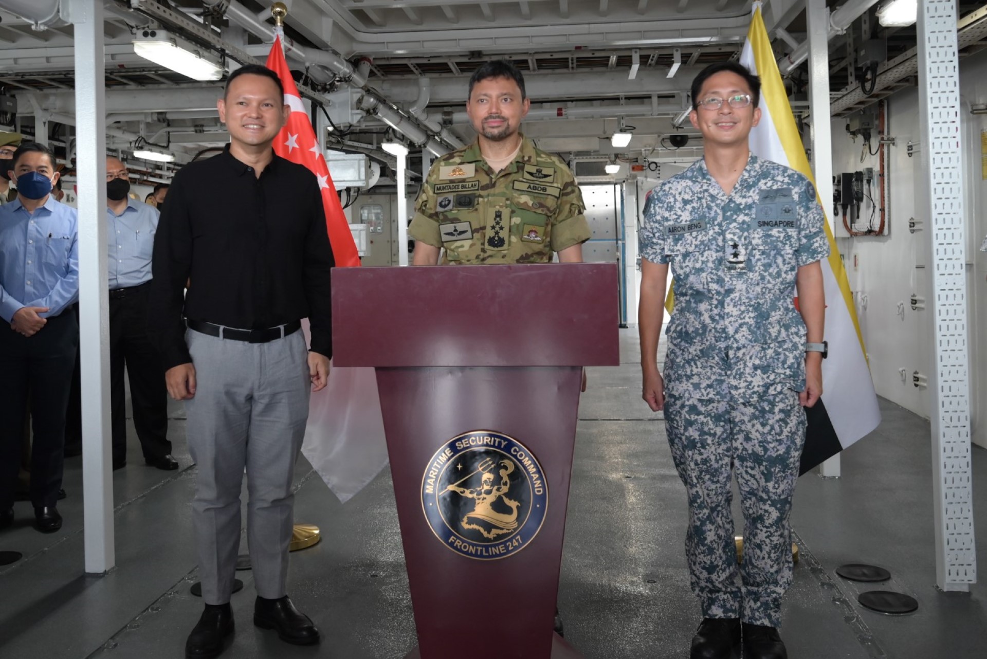 His Royal Highness (middle) after signing a guest book, with SMS Zaqy (left) and Chief of Navy Rear-Admiral Aaron Beng (right).