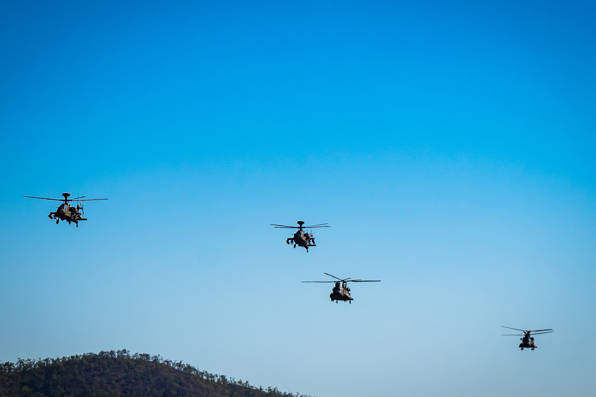 The RSAF's CH-47F Chinook and AH-64D Apache helicopters conducting joint training in the SWBTA during XWB21.