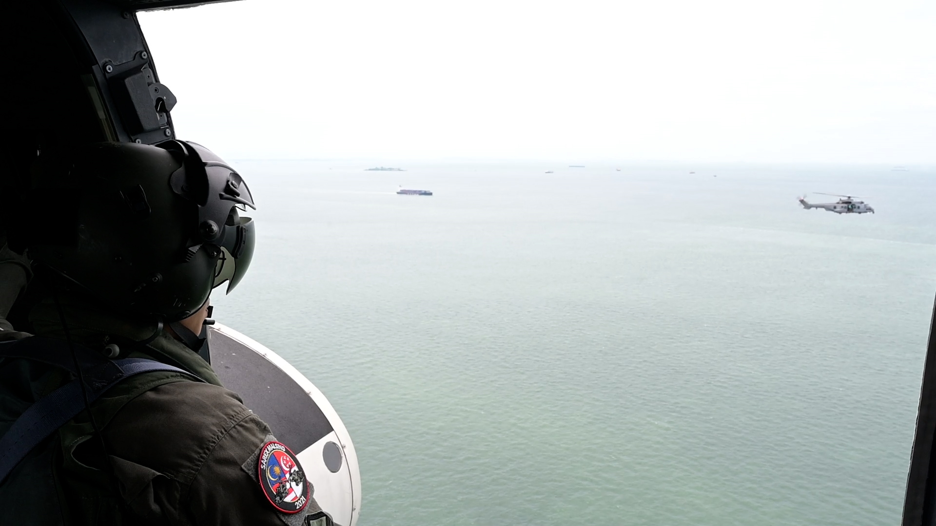 An RMAF EC725 helicopter (background) conducting Search and Locate operations with an RSAF AS322M Super Puma helicopter, as part of the combined FTX.