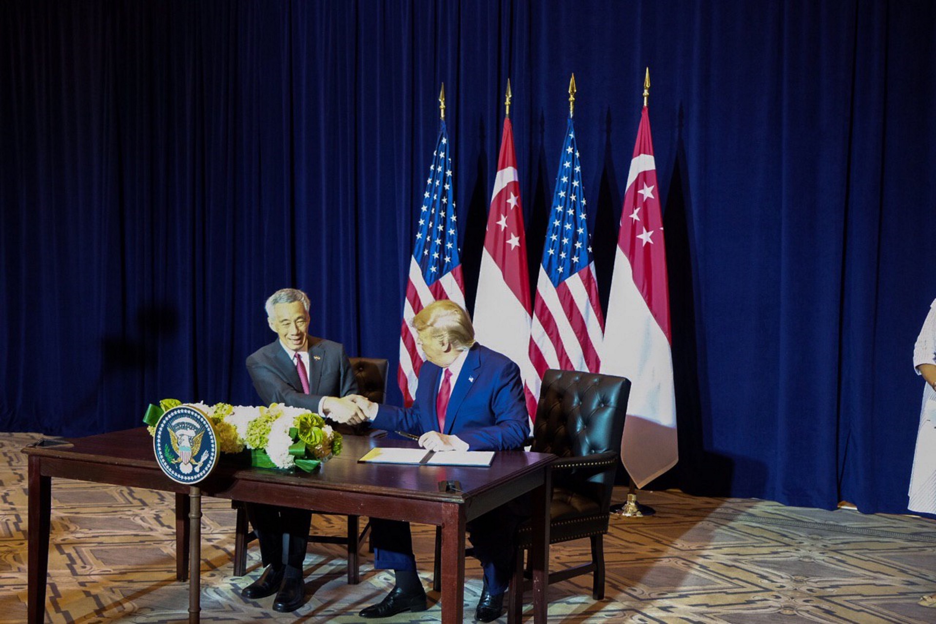 Prime Minister (PM) Lee Hsien Loong and President of the United States of America Donald Trump shaking hands after signing the Protocol of Amendment to the 1990 Memorandum of Understanding Regarding United States Use of Facilities in Singapore. 