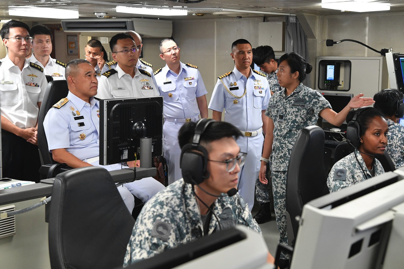 ADM Cherngchai (left) receiving a capability brief on board RSS Endeavour. 