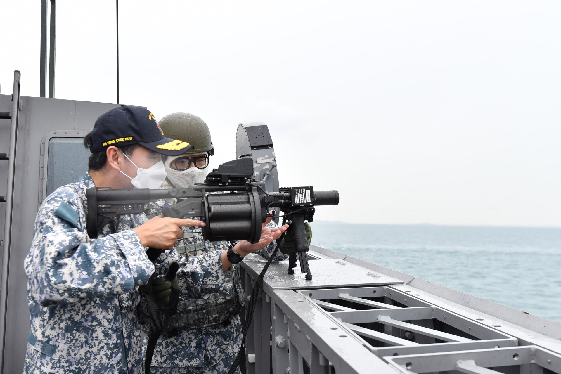 Senior Minister of State for Defence Mr Heng Chee How handling the Extended Range Grenade Launcher, a new Maritime Security and Response Vessel (MSRV) capability, on board MSRV Guardian.