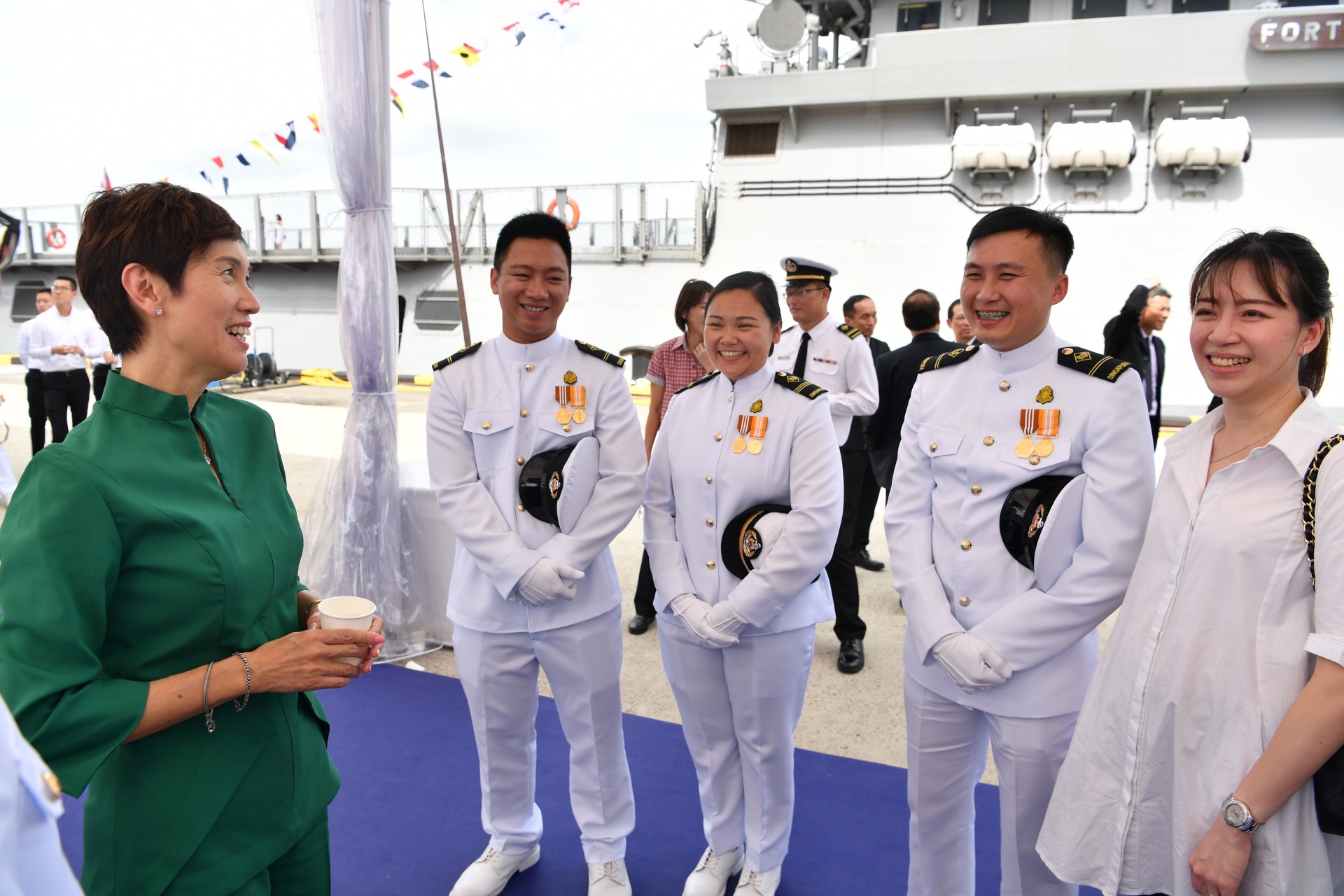 Mrs Teo interacting with RSS Fortitude's crew and their family members.