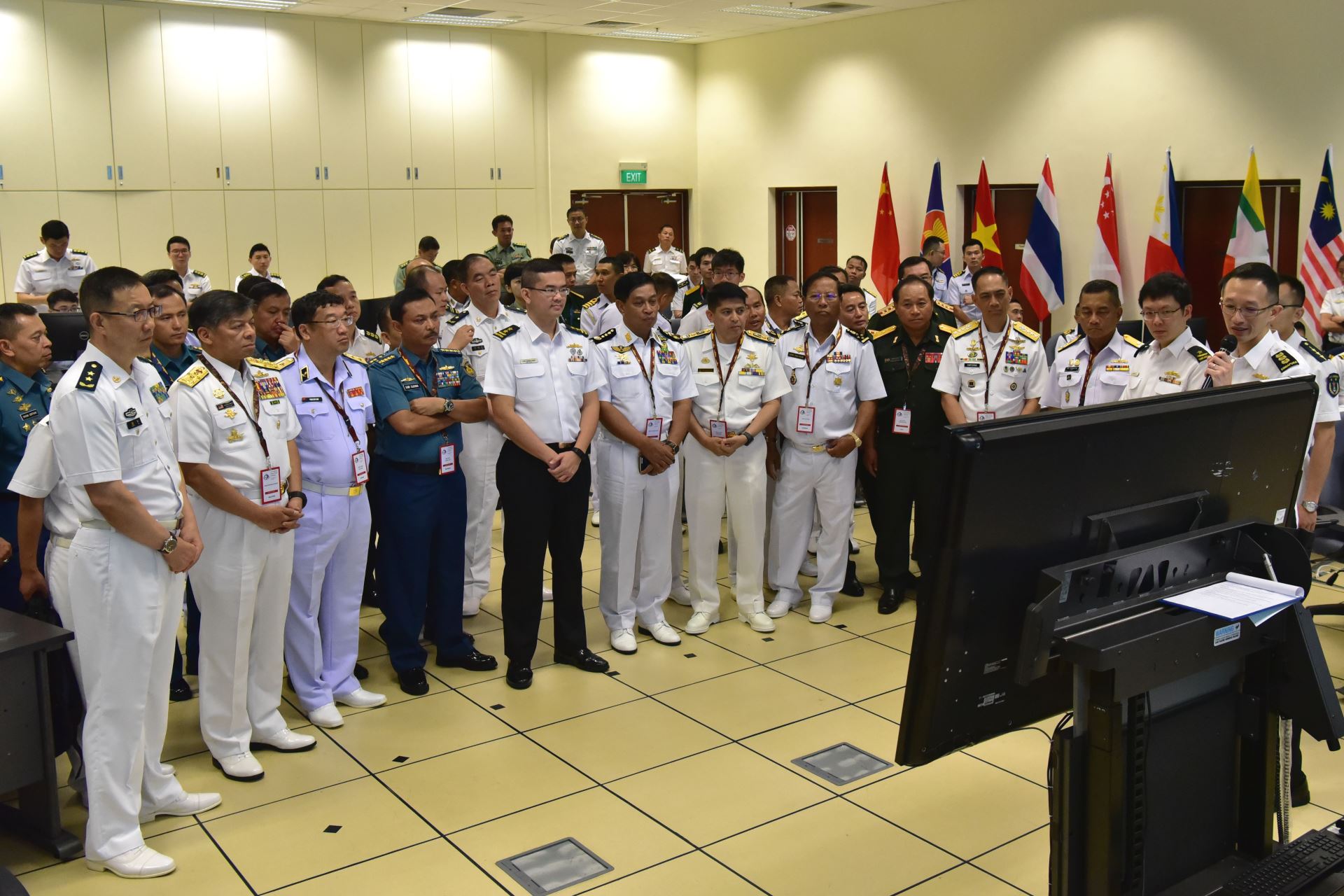 ASEAN Navy Chiefs accompanied by senior officials from ASEAN and People's Liberation Army during the brief by COL Lim (far right) on the TTX scenarios.