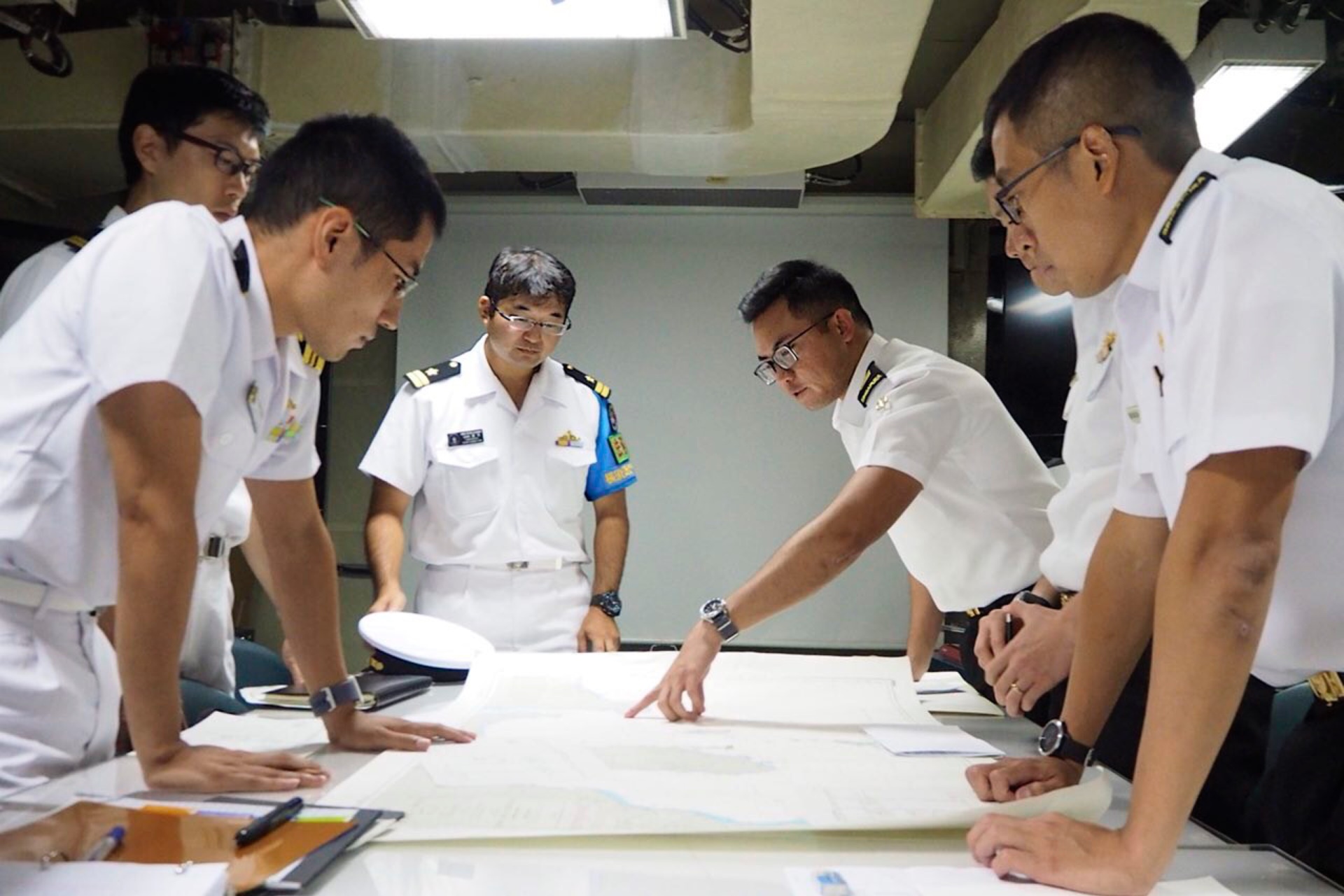 Republic of Singapore Navy (RSN) and Japan Maritime Self-Defense Force (JMSDF) personnel planning for the passage exercise on board RSS Tenacious.