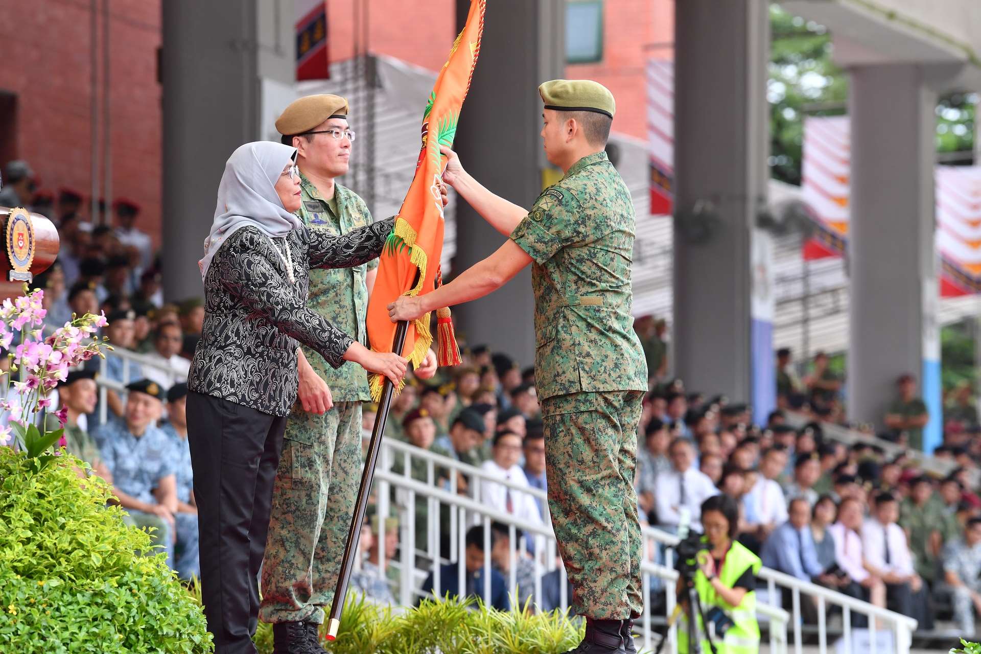 President Halimah presenting the new Regimental Colours to 9th Battalion, Singapore Infantry Regiment (9 SIR) received by Lieutenant Colonel Ong Chin Chuan, CO 9 SIR.