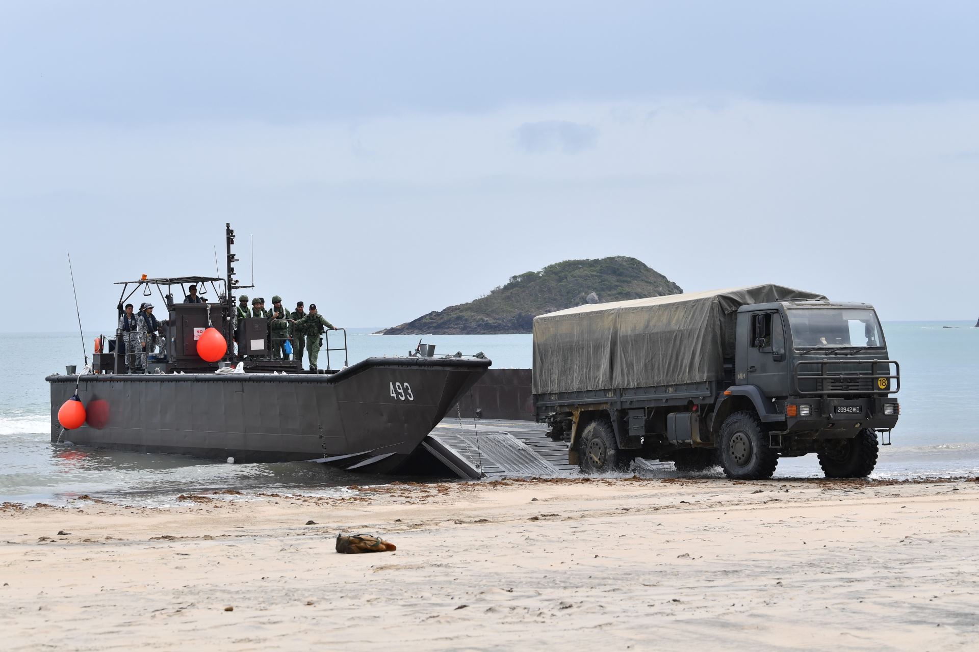 A 5-Tonner vehicle disembarking from the Fast Craft Utility during a ship-to-shore operation during Exercise Trident.