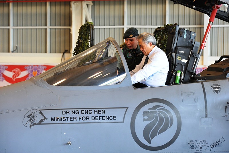 Dr Ng receiving a brief on the capabilities of the F-15SG from MAJ Nick Wong inside the cockpit of the aircraft.