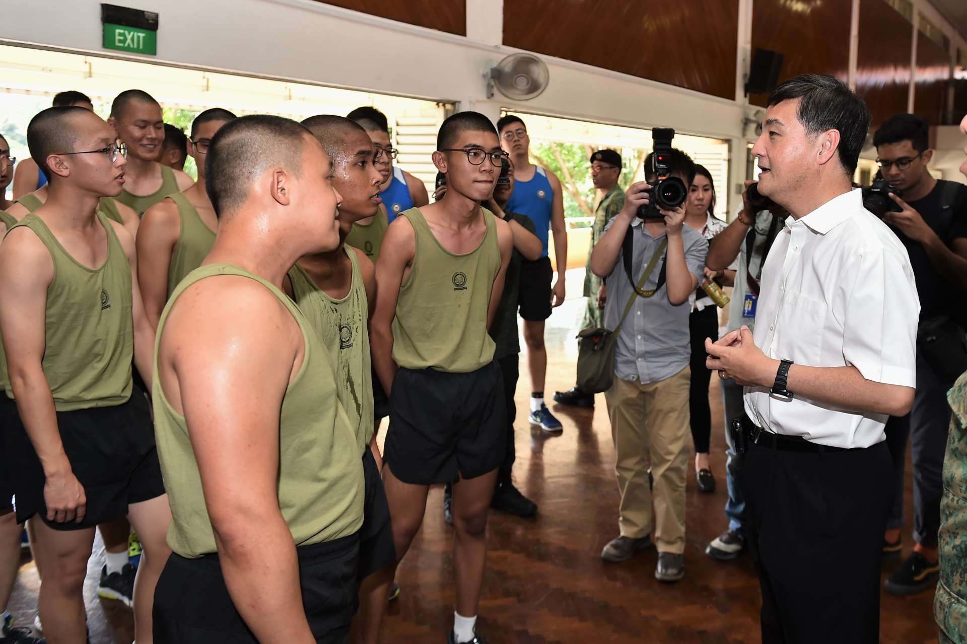 Senior Minister of State for Defence Mr Heng Chee How interacting with service-fit recruits during his visit to BMTC School V.