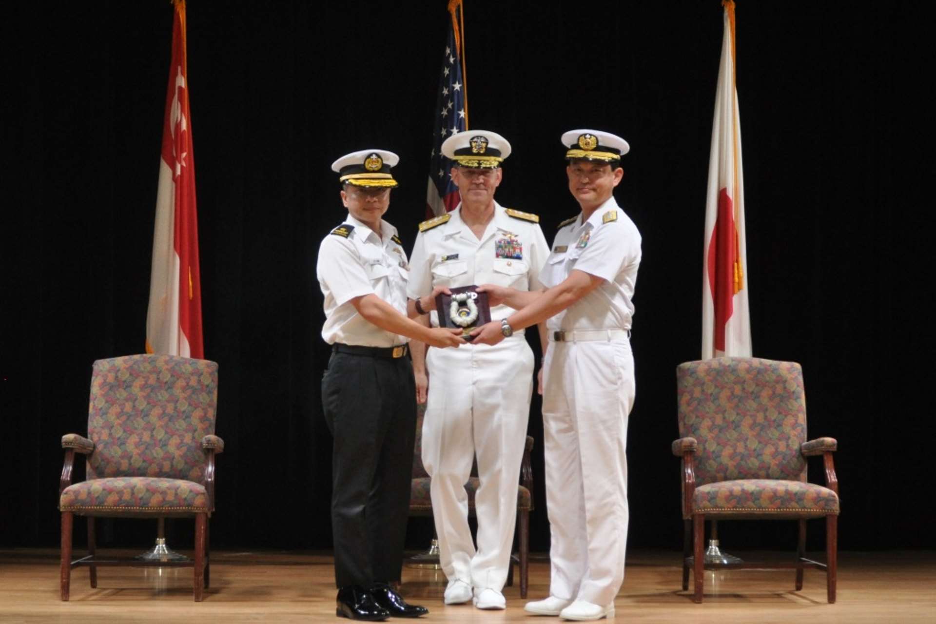 Rear-Admiral (RADM) Saw Shi Tat (left) taking over the command of CTF 151 from outgoing Commander RADM Daisuke Kajimoto (right), at the Change of Command Ceremony in the presence of Commander, Combined Maritime Forces, Vice Admiral Scott A. Stearney.