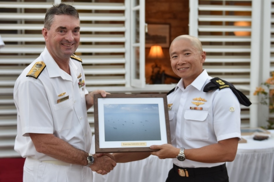 Commanding Officer RSS Valiant Lieutenant Colonel Tan Say Yong (right) receiving a commemorative gift from Fleet Commander of the Royal Australian Navy RADM Jonathan Mead (left) at the closing ceremony of Exercise Kakadu 2018.