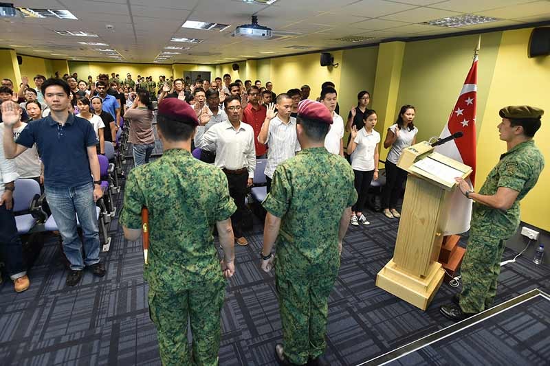 SAFVC Volunteers during the oath-taking ceremony led by Lieutenant Colonel James Yin, Head Training and Plans Branch of the SAF Volunteer Corps (extreme right).