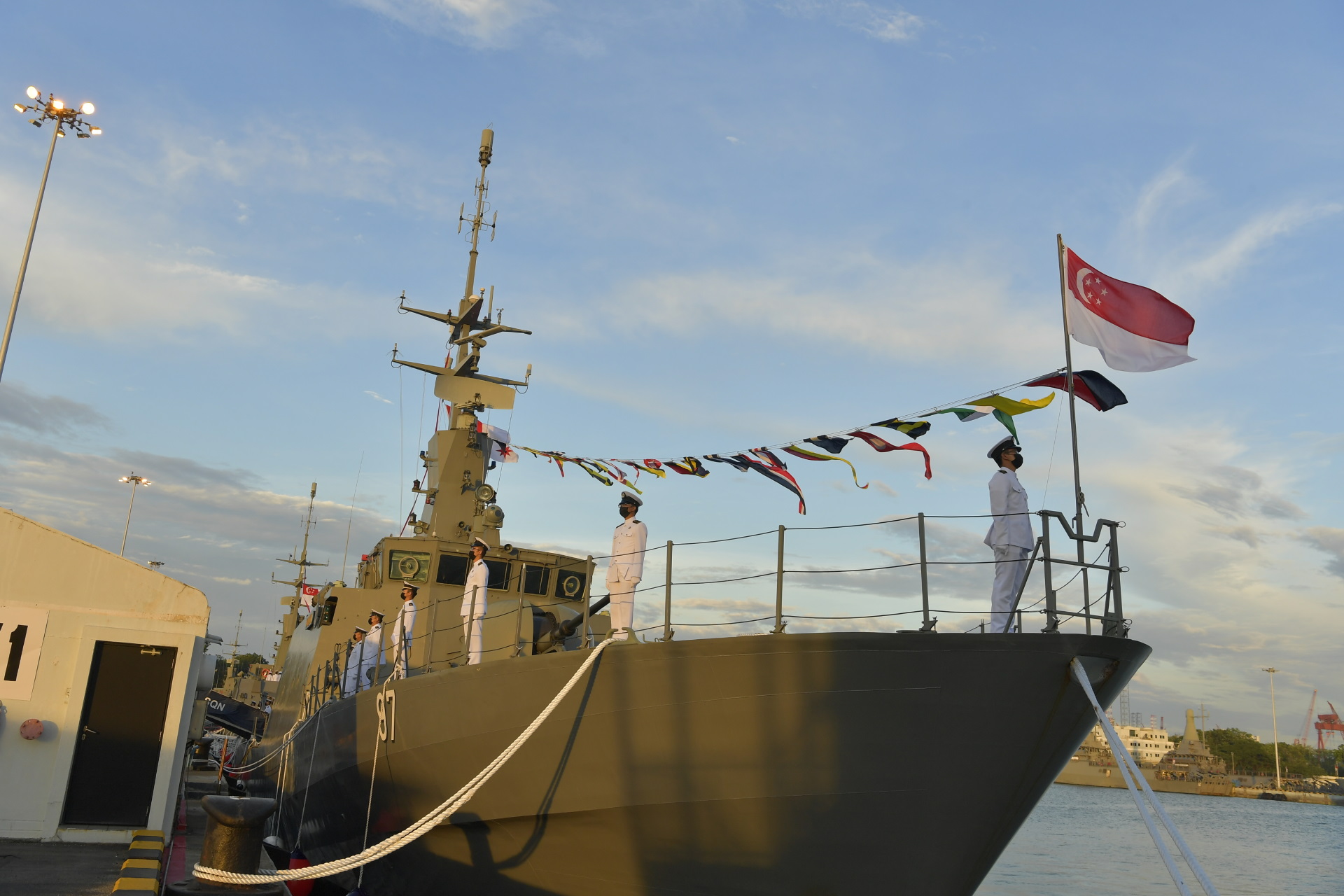 The crew of The Republic of Singapore Navy (RSN) Patrol Vessel, RSS Gallant, lining the ship during the sunset decommissioning ceremony at Tuas Naval Base on 11 Dec.