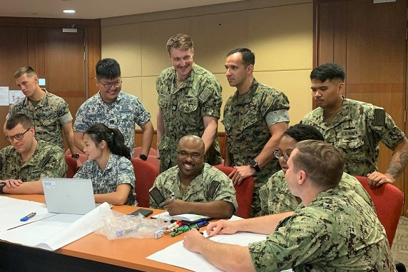 RSN and USN personnel interacting during the planning exercise.