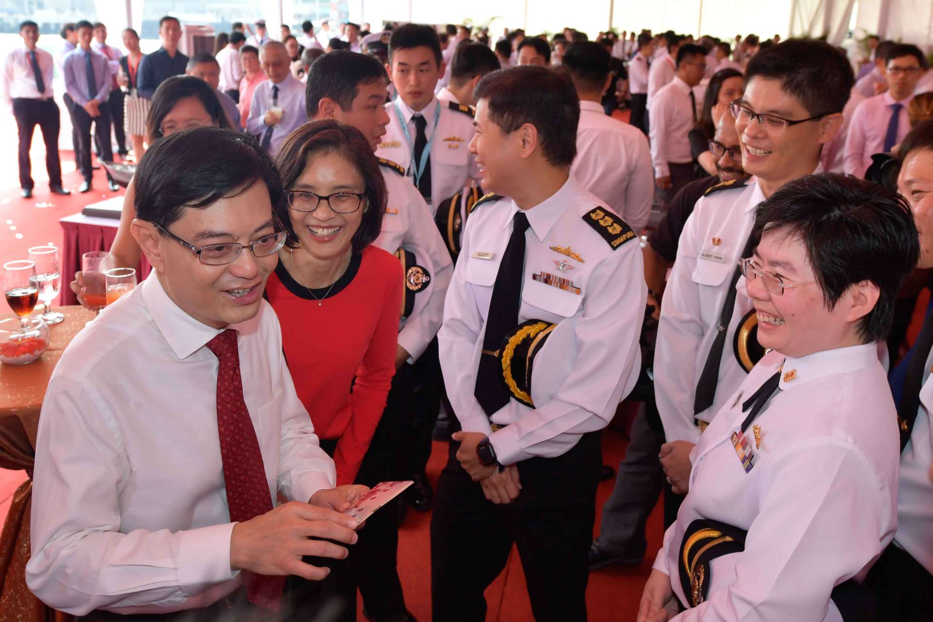 Minister Heng (left) interacting with former crew members of other RSN vessels at the launch ceremony.