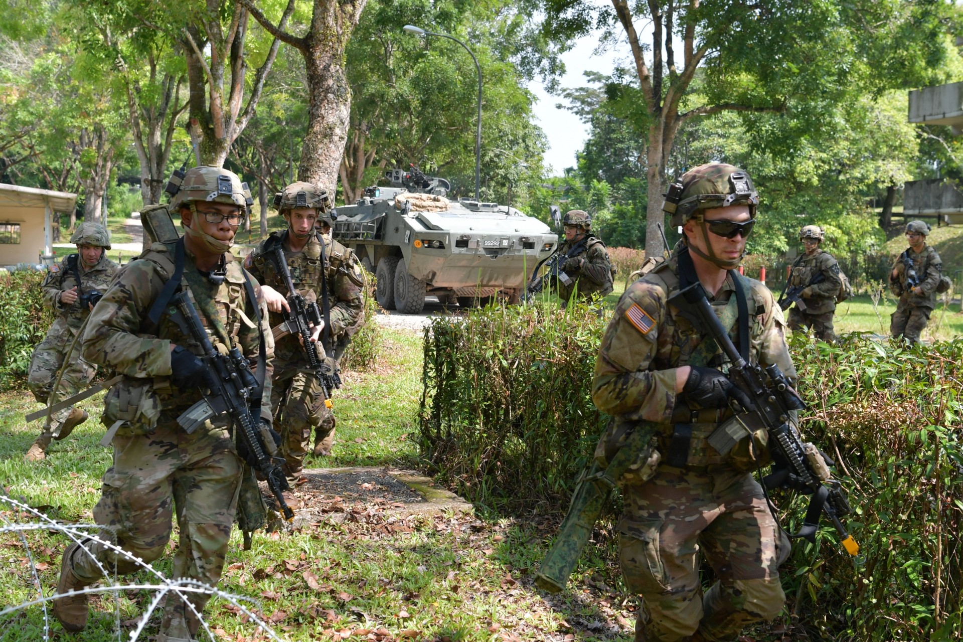 US Army personnel advancing on an urban objective at Murai Urban Training Facility.