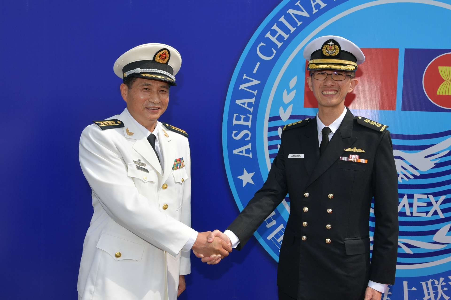 Exercise co-directors, Colonel Lim Yu Chuan (right) from the RSN and Senior Captain Zhu Jianda (left) from the People's Liberation Army Navy (PLAN), congratulating each other on the successful conclusion of the exercise.