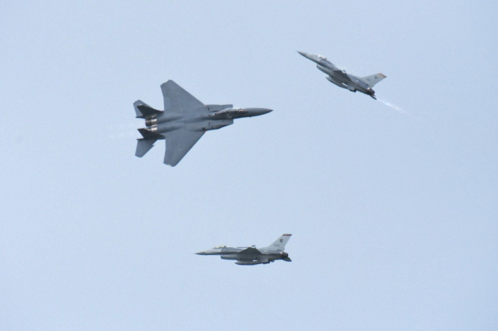 The F-15SG and F-16C fighter aircraft performing the ''3-Ship Low and Slow & High Speed Pass'' as part of the RSAF's aerial display at SA18.