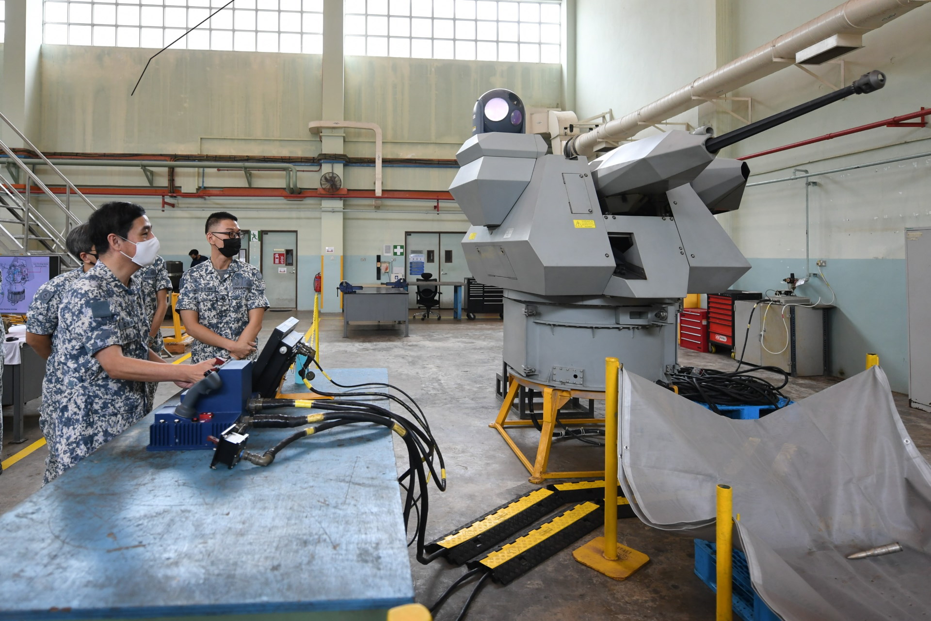 Senior Minister of State for Defence Mr Heng Chee How testing out the Typhoon Gun alignment process – a solution developed by NALCOM personnel to conduct the process ashore.