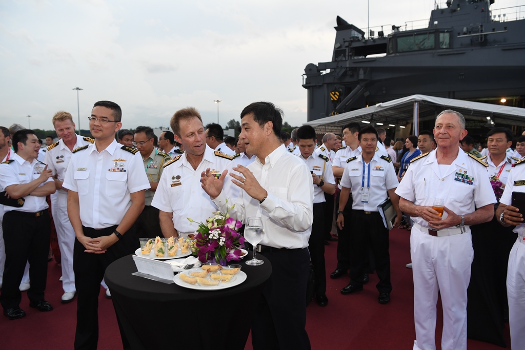 Mr Heng interacting with navy chiefs while observing cultural performances by the various navies during the cocktail reception.