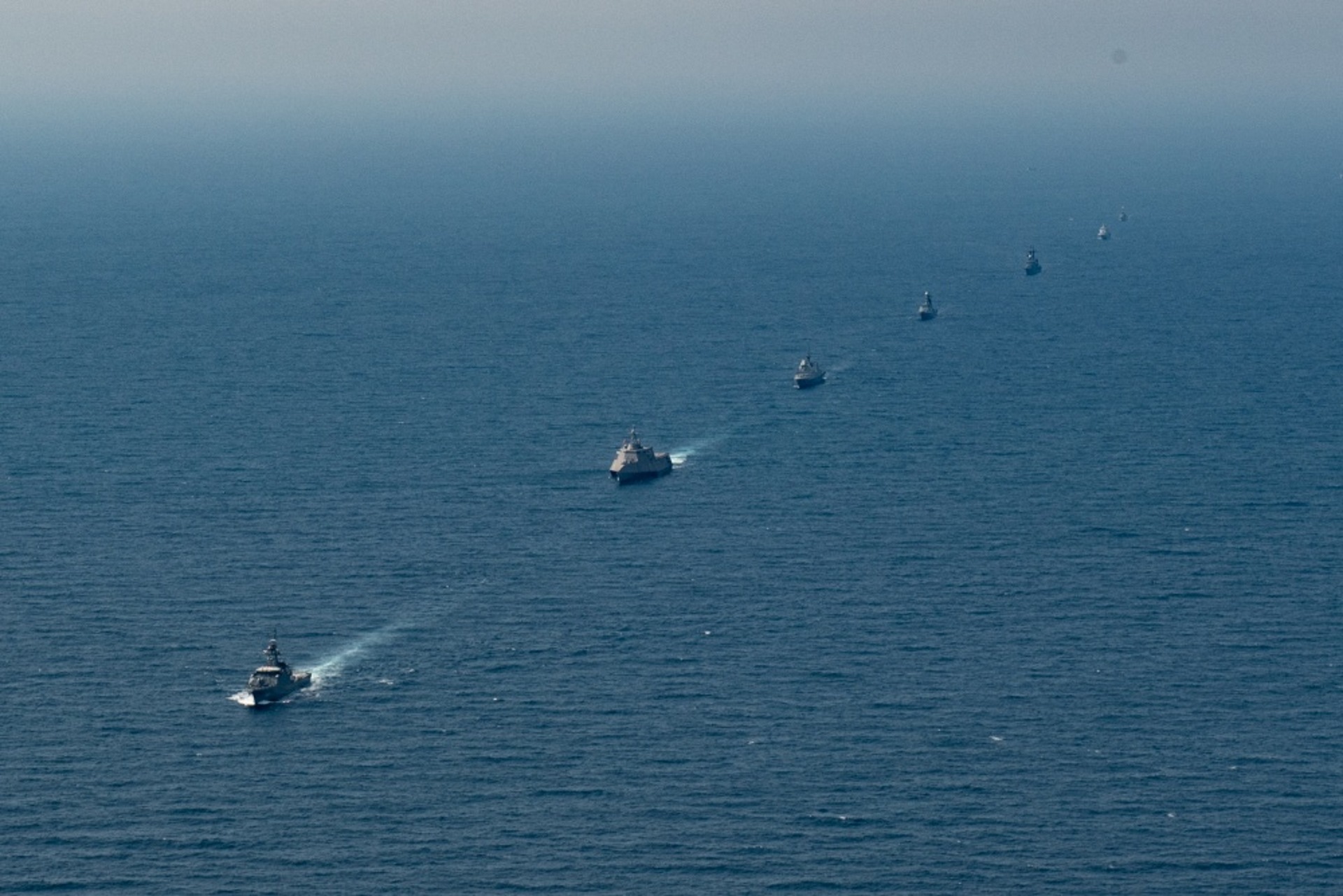 Ships from the participating navies sailing in formation during the AUMX.