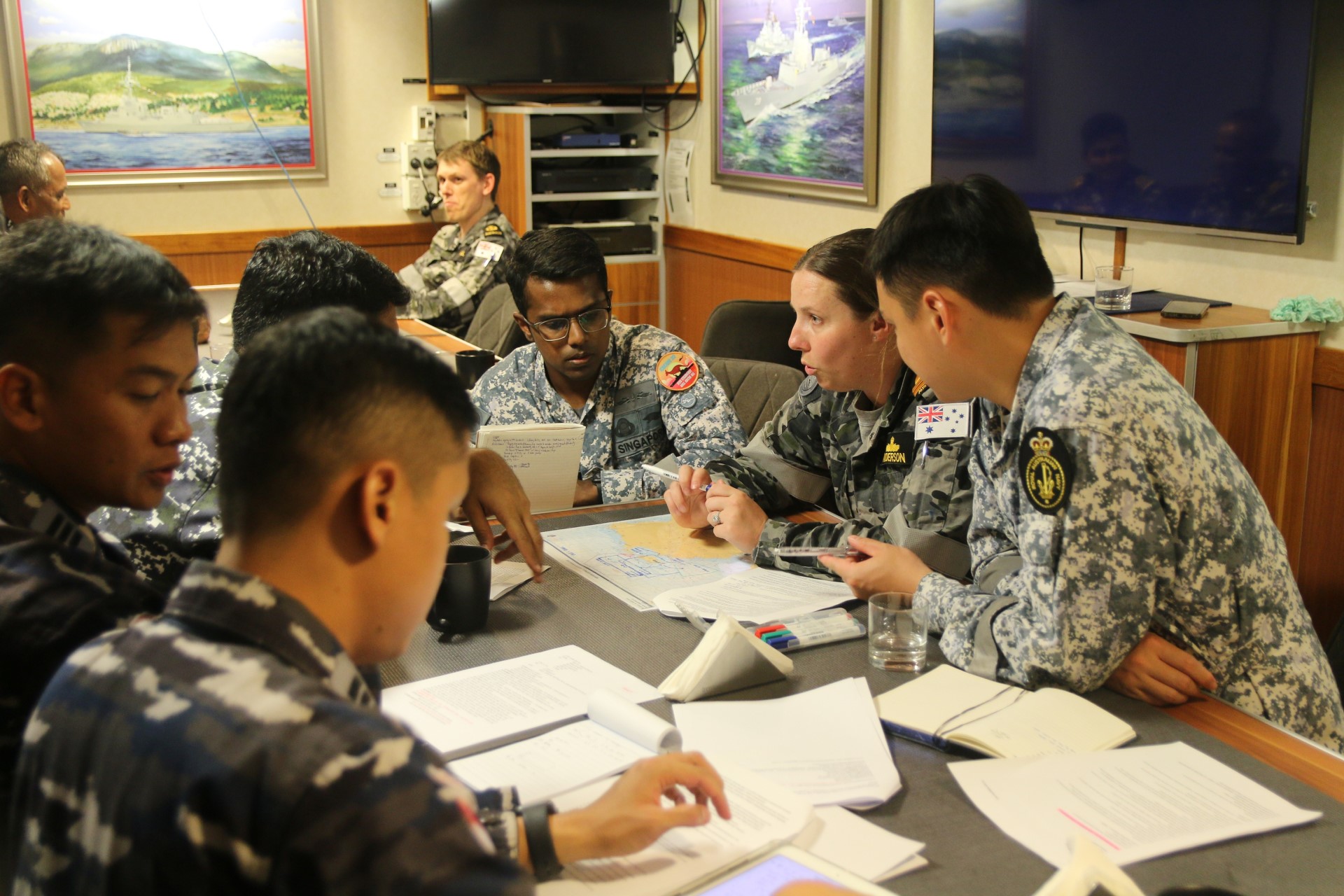 RSN personnel conducting planning for the exercise with personnel from the Royal Australian Navy (RAN) and the Indonesian Navy (TNI AL).