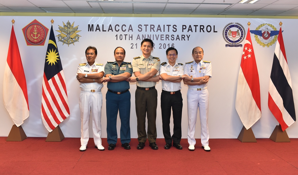 The Chiefs of Navy of Indonesia, Singapore and Thailand, Malaysia's Deputy Chief of Navy, and Singapore's Chief of Defence Force linking arms in a gesture of cooperation at the Malacca Straits Patrol 10th Anniversary Commemorative Events.
