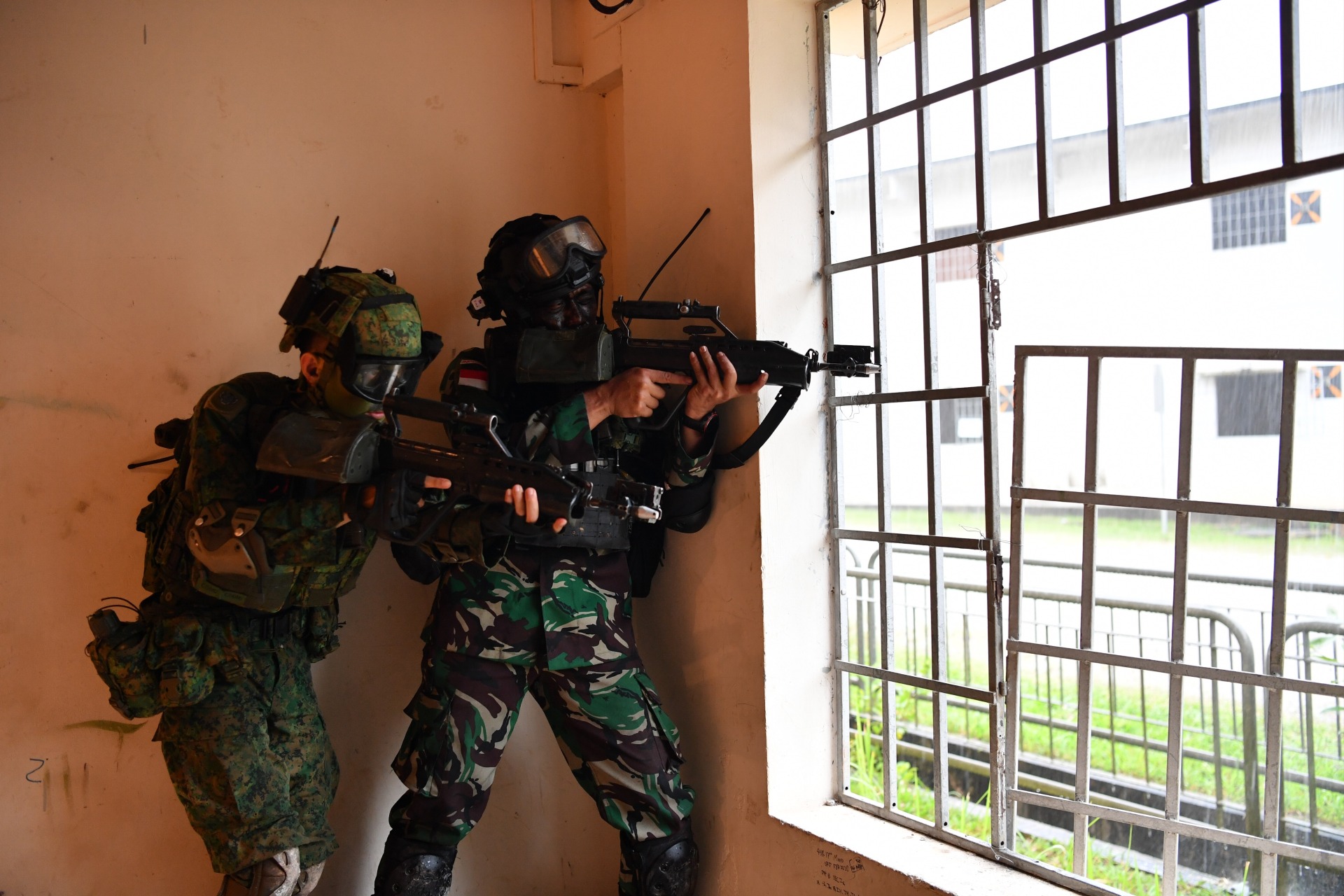 Soldiers from the Singapore Army and the Indonesia Army (TNI-AD) working together to secure the urban objective.