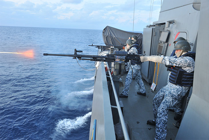 Singapore Navy soldiers firing on board one of the frigate