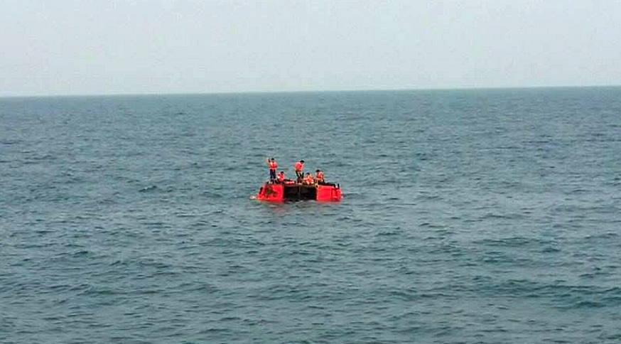 Five crew members staying afloat on the capsized fishing trawler.