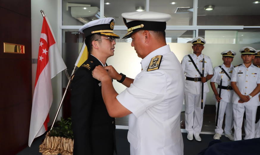 RADM Beng (left) being presented with the RBN Command Badge.
