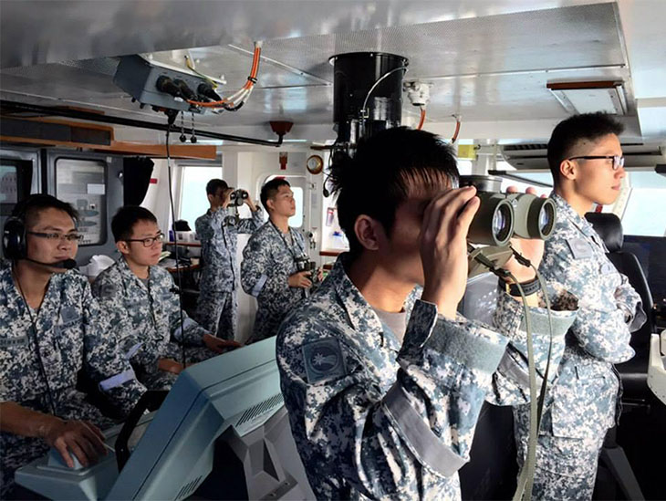 Navy soldiers in the control station aboard ship