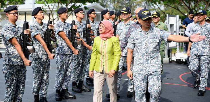 President Halimah Yacob inspecting a Line of Honour as she boards the Republic of Singapore Navy